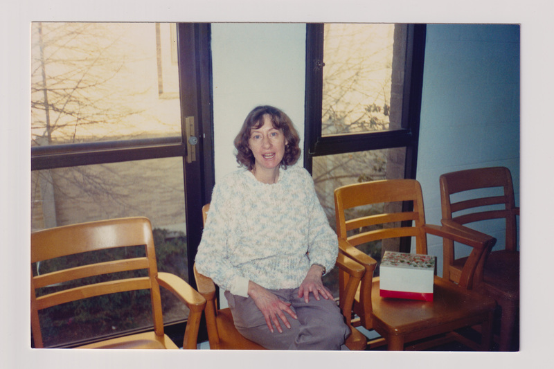 Woman Sitting Alone in a Row of Chairs