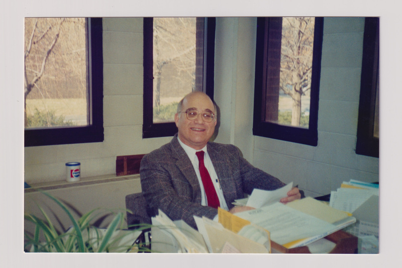 Man Sitting in an Office with Files