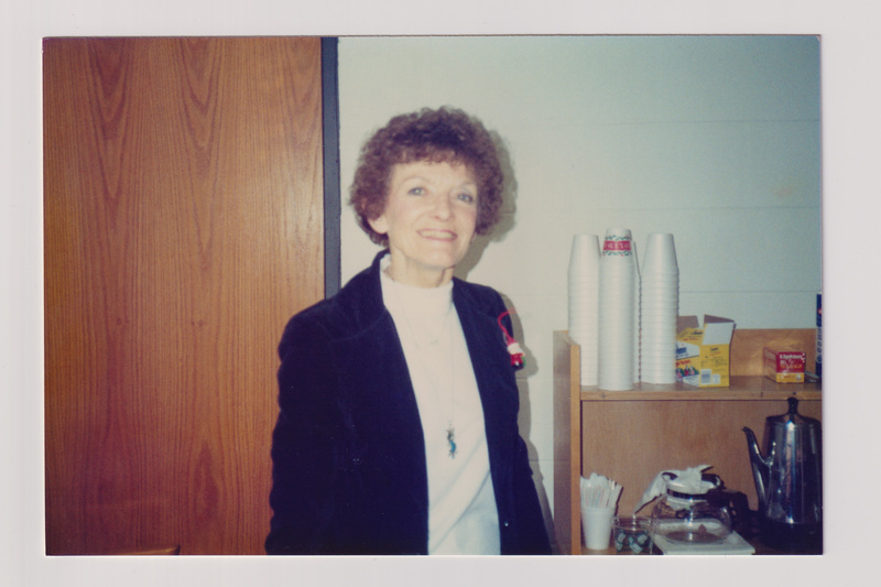 Woman Smiling in Office Kitchen