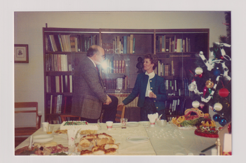 Man and Woman Talking Behind a Table