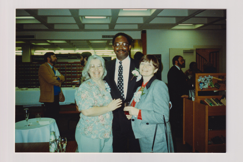 Three People Smiling at Library Party
