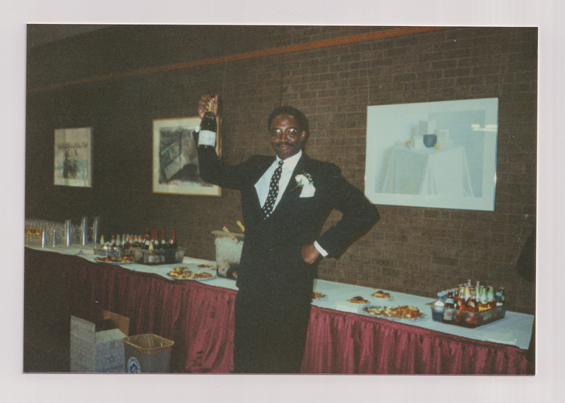 Man Holding Up a Bottle of Champagne