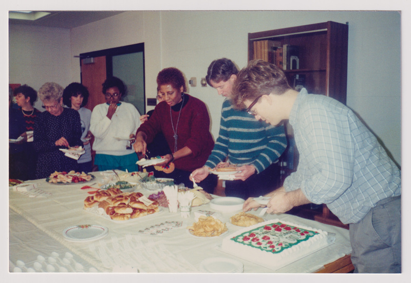 People Getting Food From Refreshment Table