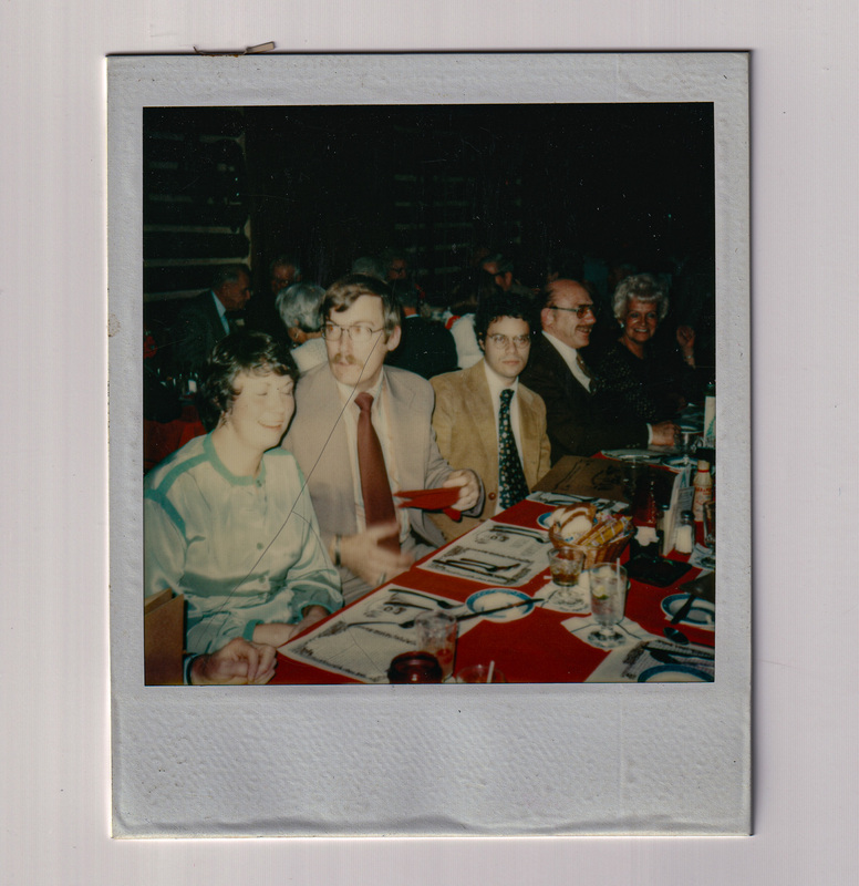 Sitting on One Side of Table at Holiday Party