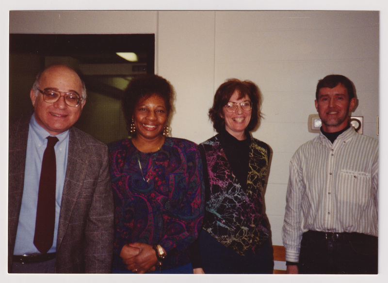 Four People Pose Standing at the Party
