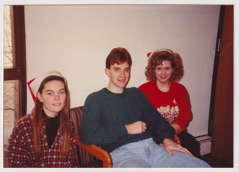 Three People Pose Sitting at the Party