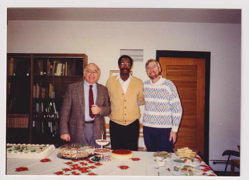 Three Men Pose Over Desserts