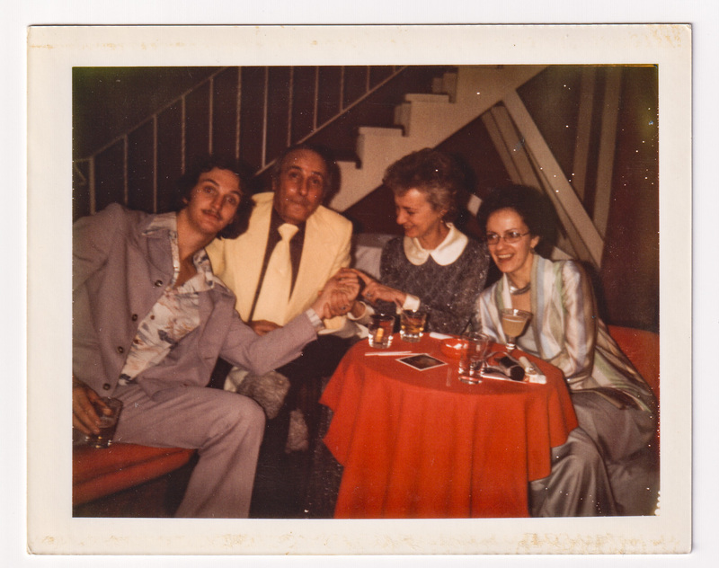 Henry, Sam, Linda, and Elaine seated at Holiday Party